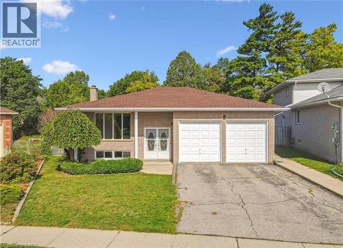 Brick exterior featuring a hip roof and a two-car garage - 42 Azores Crescent, Cambridge, ON - Outdoor