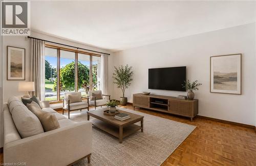 **Virtually Staged** Living area featuring expansive picture windows, wood-finish parquet flooring, and a neutral color palette - 42 Azores Crescent, Cambridge, ON - Indoor Photo Showing Living Room