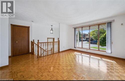 Living space featuring parquet wood-finish flooring and a large picture window - 42 Azores Crescent, Cambridge, ON - Indoor Photo Showing Other Room