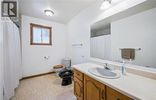 Bathroom with a wood-finish vanity, integrated white sink, and a large wall-mounted mirror - 42 Azores Crescent, Cambridge, ON - Indoor Photo Showing Bathroom