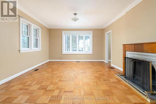 Main floor living room with wood burning fireplace - 52 Briarwood Avenue, Mississauga, ON - Indoor Photo Showing Other Room With Fireplace