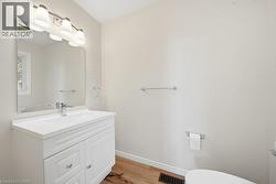 Vanity with integrated sink, chrome faucet, and white cabinetry - 