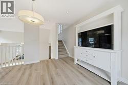 Light wood-finish flooring extending through the space - 