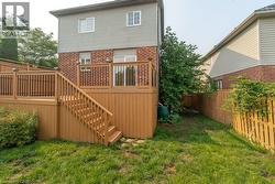 Multi-level wood-finish deck featuring dark balusters and integrated lighting - 
