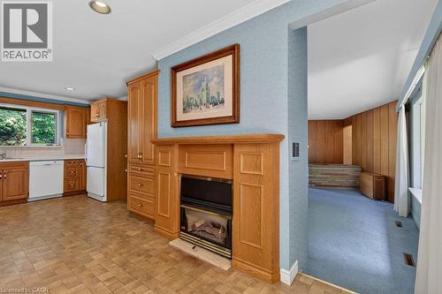 gas fireplace warms the large eat in kitchen - 44 Colquhoun Crescent, Hamilton, ON - Indoor With Fireplace