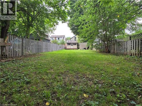 Expansive grassy yard with mature trees providing partial shade - 109 Sydenham Street, Brantford, ON - Outdoor
