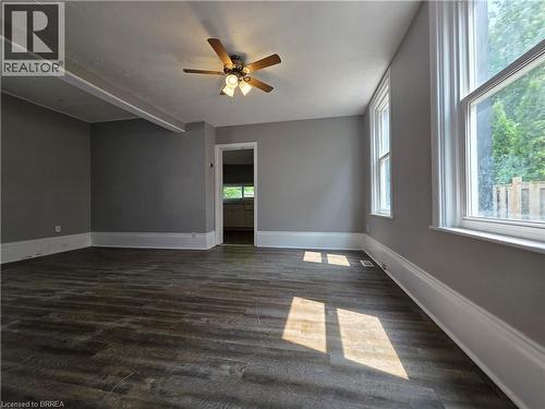 Spacious interior room featuring wood-finish flooring, neutral gray wall tones, and white trim - 109 Sydenham Street, Brantford, ON - Indoor Photo Showing Other Room