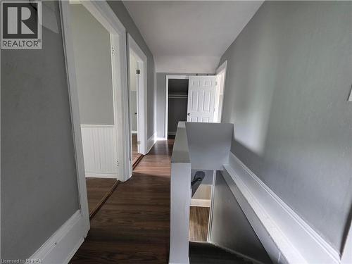 Upper-level hallway featuring wood-finish flooring, light gray walls, and white trim - 109 Sydenham Street, Brantford, ON - Indoor Photo Showing Other Room