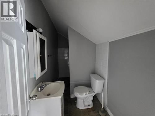 Bathroom featuring a white vanity with integrated sink, chrome faucet, and mirrored medicine cabinet - 109 Sydenham Street, Brantford, ON - Indoor Photo Showing Bathroom