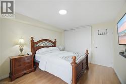 Light wood-finish flooring complements the neutral wall color - 