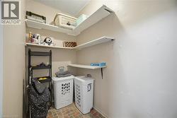 Utility area featuring multi-level wall-mounted shelving, corner shelving, and a patterned tile floor - 
