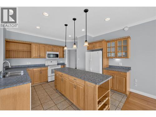 Large kitchen with island, peninsula, and pantry. - 7083 Jasper Drive, Vernon, BC - Indoor Photo Showing Kitchen With Double Sink