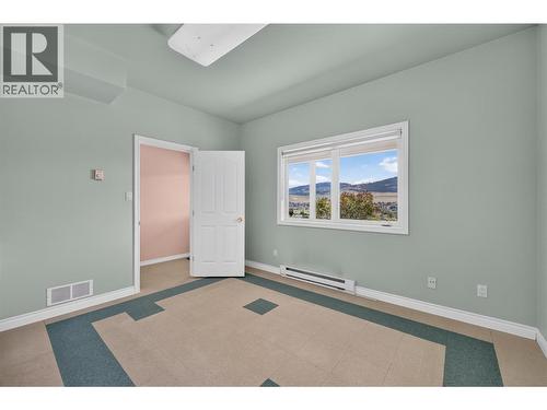 Bar bonus room with endless possibilities. Perfect as a speakeasy, an art studio, hobby room, fitness space, or entertaining lounge. - 7083 Jasper Drive, Vernon, BC - Indoor Photo Showing Other Room