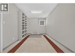 The perfect space for a home-based business. With utility sink, extensive built-in shelving, and ample workspace. - 