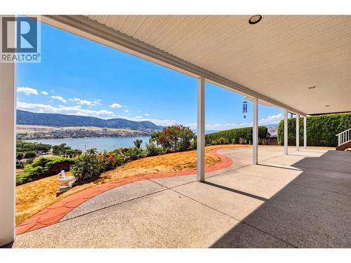 Large, covered lower patio. - 7083 Jasper Drive, Vernon, BC - Outdoor With Body Of Water