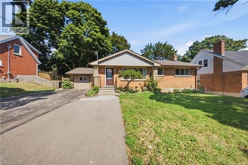Brick and siding exterior featuring a covered entry, a paved driveway, and established landscaping - 80 Jackson Avenue, Kitchener, ON - Outdoor
