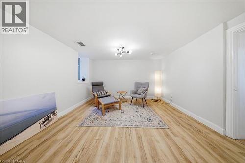 Spacious room featuring light wood-finish flooring, crisp white walls, and a recessed window - 80 Jackson Avenue, Kitchener, ON - Indoor