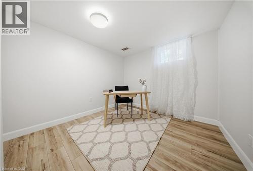 Bright room with wood-finish flooring, crisp white walls, and a recessed window - 80 Jackson Avenue, Kitchener, ON - Indoor Photo Showing Other Room