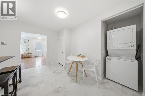 Dedicated laundry closet featuring a stacked washer and dryer - 80 Jackson Avenue, Kitchener, ON - Indoor Photo Showing Laundry Room