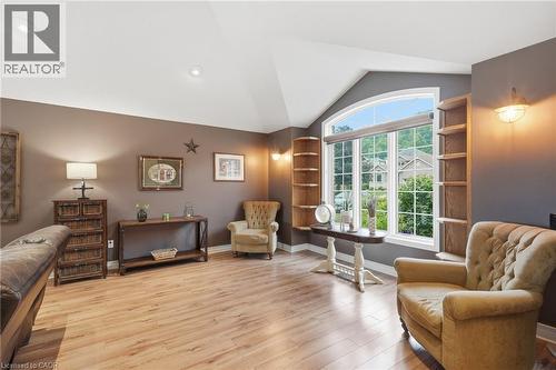 Spacious living area featuring vaulted ceilings, wood-finish flooring, and an arched window - 5 Manor Crescent, Grimsby, ON - Indoor Photo Showing Other Room