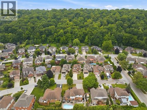 Residential neighborhood with varied architectural styles and mature trees, bordered by a dense forest - 5 Manor Crescent, Grimsby, ON - Outdoor With View