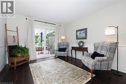 Hardwood-finish flooring throughout, beadboard wainscoting, and white walls - 