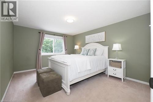 Carpeted bedroom with a single window and recessed lighting - 218 Inverhuron Crescent Unit# A, Waterloo, ON - Indoor Photo Showing Bedroom