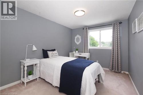 Bedroom featuring a single window with a white frame, light gray walls, and light-colored carpeting - 218 Inverhuron Crescent Unit# A, Waterloo, ON - Indoor Photo Showing Bedroom