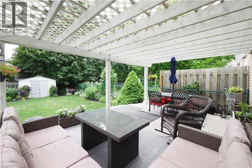 Covered patio area featuring a white wood pergola - 218 Inverhuron Crescent Unit# A, Waterloo, ON - Outdoor With Deck Patio Veranda