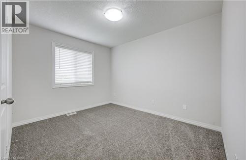 Room featuring light gray carpet, white painted walls, and a single window with blinds - 823 Paris Boulevard, Waterloo, ON - Indoor Photo Showing Other Room