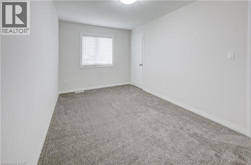 Soft gray carpeting with white baseboards and light-toned walls - 823 Paris Boulevard, Waterloo, ON - Indoor Photo Showing Other Room