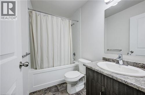 Bathroom featuring a single vanity with a granite-style countertop, undermount sink, and chrome faucet - 823 Paris Boulevard, Waterloo, ON - Indoor Photo Showing Bathroom