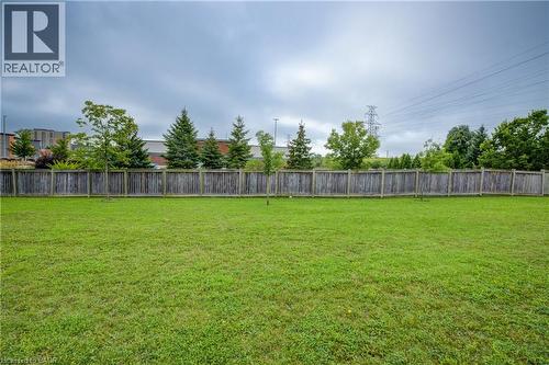 Expansive backyard featuring a lush green lawn and perimeter wooden fencing - 823 Paris Boulevard, Waterloo, ON - Outdoor