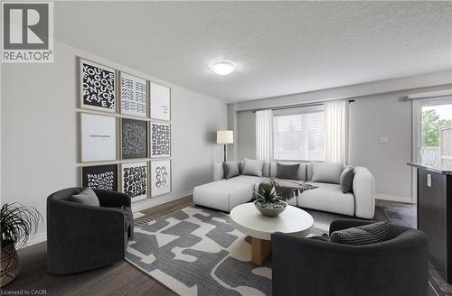 Spacious living area featuring wood-finish flooring, a large window with blinds, and a glass-paneled door leading to an outdoor area - 823 Paris Boulevard, Waterloo, ON - Indoor Photo Showing Living Room