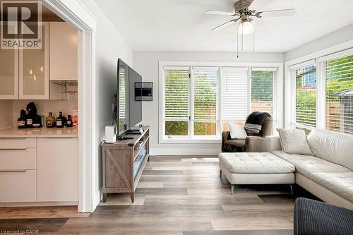 Living area featuring multiple windows with blinds, a ceiling fan, and wood-finish flooring - 67 Weber Street S, Waterloo, ON - Indoor Photo Showing Living Room