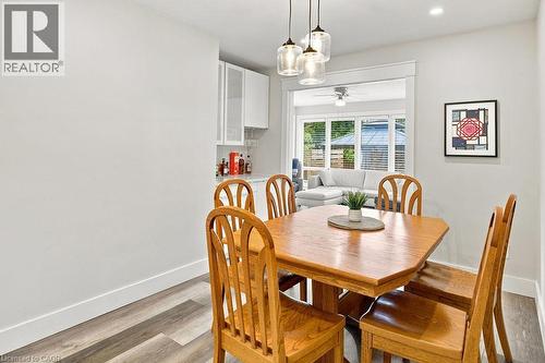 Dining area featuring wood-finish flooring, recessed lighting, and a contemporary three-light pendant fixture - 67 Weber Street S, Waterloo, ON - Indoor Photo Showing Dining Room