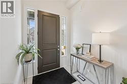 Entryway featuring a dark paneled door with glass sidelights and transom window - 