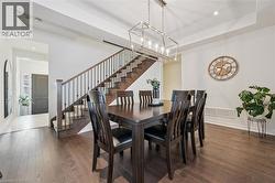 Formal dining area featuring rich wood-finish flooring - 