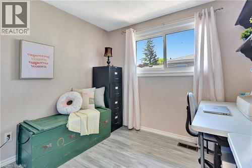 Neutral wall paint throughout this interior space featuring wood-finish flooring - 98 Belwood Crescent, Kitchener, ON - Indoor