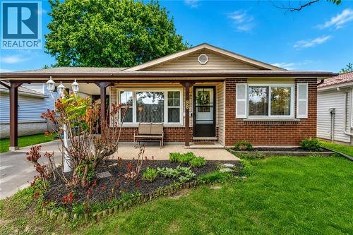Brick facade residence with a covered carport featuring decorative pillars and overhead lighting - 98 Belwood Crescent, Kitchener, ON - Outdoor