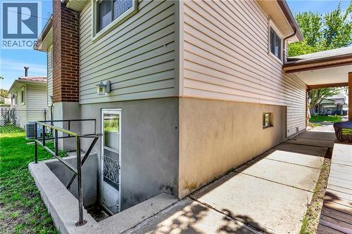 Exterior with light-toned siding and a stucco foundation - 98 Belwood Crescent, Kitchener, ON - Outdoor With Exterior