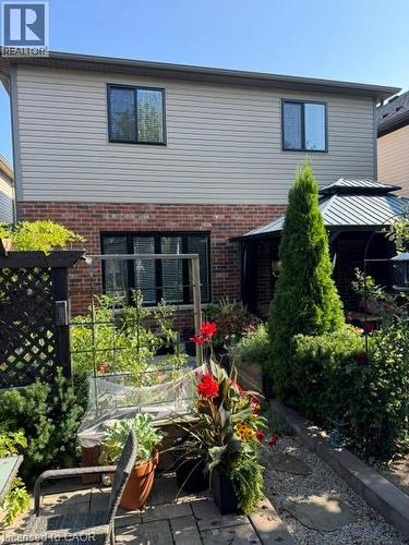 Backyard with brick lower exterior and horizontal siding upper exterior - 102 Willow Lane, Grimsby, ON - Outdoor