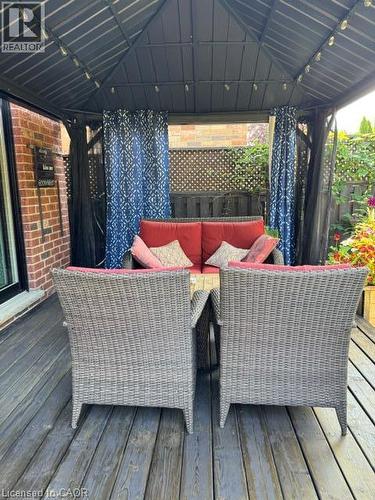 Outdoor gazebo with integrated string lighting, privacy curtains, and a wood-finish deck - 102 Willow Lane, Grimsby, ON - Outdoor With Deck Patio Veranda With Exterior