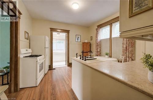 Virtually staged to add stove and fridge. - 46 Ellen Street W, Kitchener, ON - Indoor Photo Showing Laundry Room