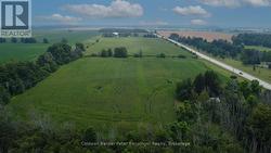 Aerial view. Tree lines north and east boundaries. - 