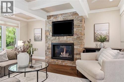 Stone-clad fireplace with a built-in television mount - 266 Ferndale Place, Waterloo, ON - Indoor Photo Showing Living Room With Fireplace