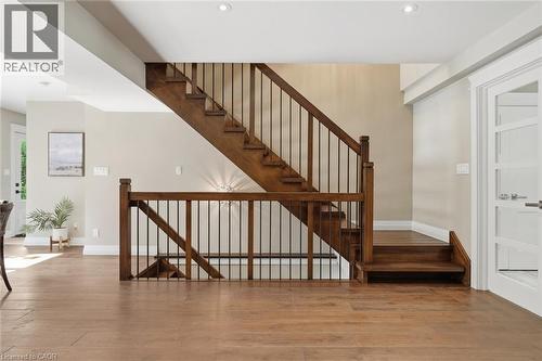Hardwood flooring throughout featuring a wood staircase with black iron spindles - 266 Ferndale Place, Waterloo, ON - Indoor Photo Showing Other Room