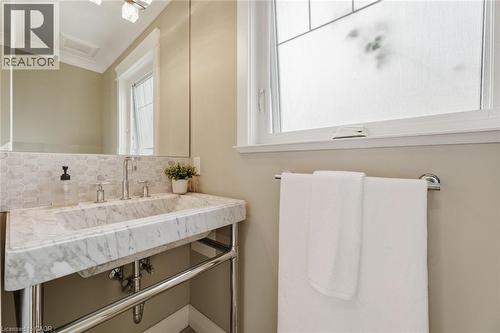 Integrated marble vanity with chrome-finish basin faucet - 266 Ferndale Place, Waterloo, ON - Indoor Photo Showing Bathroom