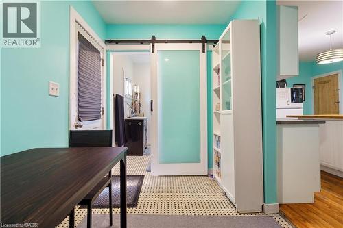 The property features a kitchen area with hardwood floors, a white cabinet, and a visible range - 219 Avondale Street, Hamilton, ON - Indoor