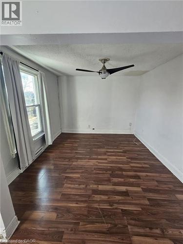 This room features a ceiling fan, a window, and wood-look flooring - 219 Avondale Street, Hamilton, ON - Indoor Photo Showing Other Room